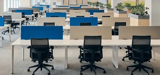 Modern open-plan office space featuring clean workstations, ergonomic chairs, and sanitized carpets provided by professional office cleaning services in Myrtle Beach, SC.