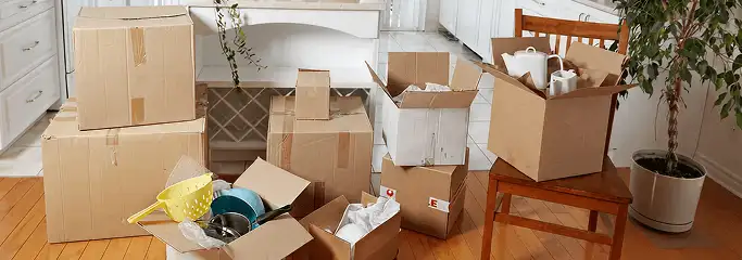 Packed moving boxes and household items in a kitchen before move-out or move-in cleaning, Myrtle Beach, SC.